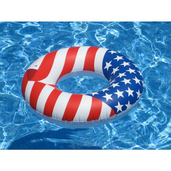 The 36 Americana Series Swim Ring, featuring red and white stripes with white stars on a blue background, floats in a clear blue swimming pool.