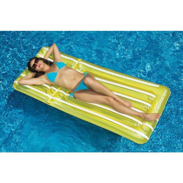 A woman in sunglasses and a blue bikini is relaxing on the Cool Stripe Mattress, floating on a clear blue swimming pool.