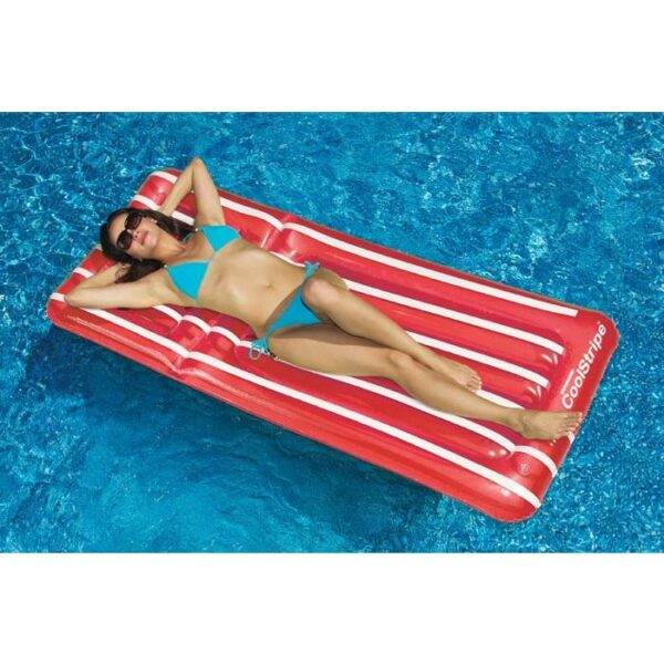 A woman in a blue bikini and sunglasses relaxes on the Cool Stripe Matress, a red and white inflatable pool float, lying on her back in a swimming pool.