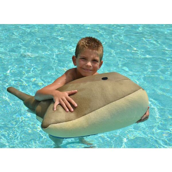 A smiling boy in a swimming pool holds the Seaside Rider - Cruz the Stingray float, with clear blue water in the background.