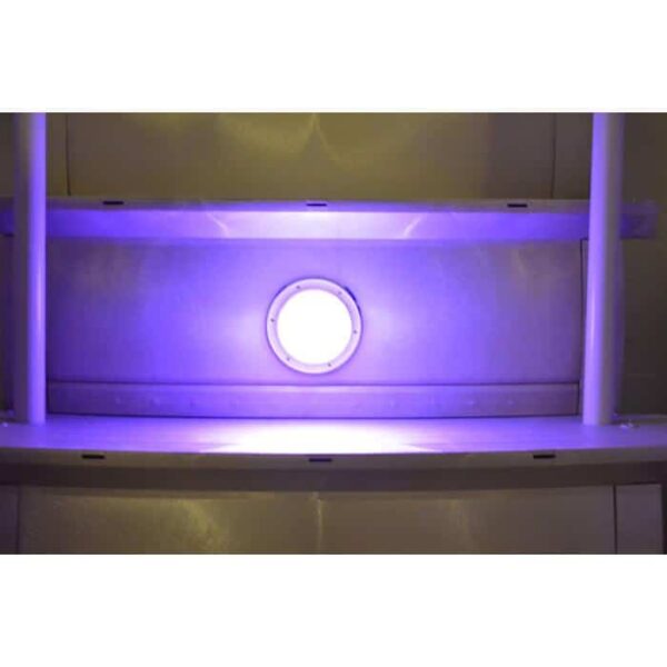 The Smart Lite features a circular ultraviolet (UV) light that emits a purple glow inside a metallic, enclosed chamber with white support bars along the sides.