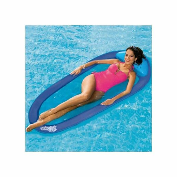 A woman in a pink swimsuit relaxes on the Spring Float Lounge, a blue inflatable pool float, in a swimming pool with clear blue water.