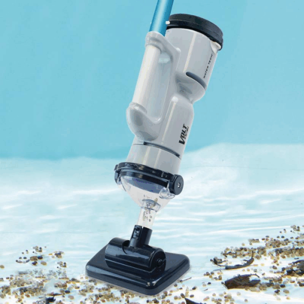 The VOLT FX-4 LI RECHARGEABLE VAC is being used underwater to remove debris and small stones from the pool floor.