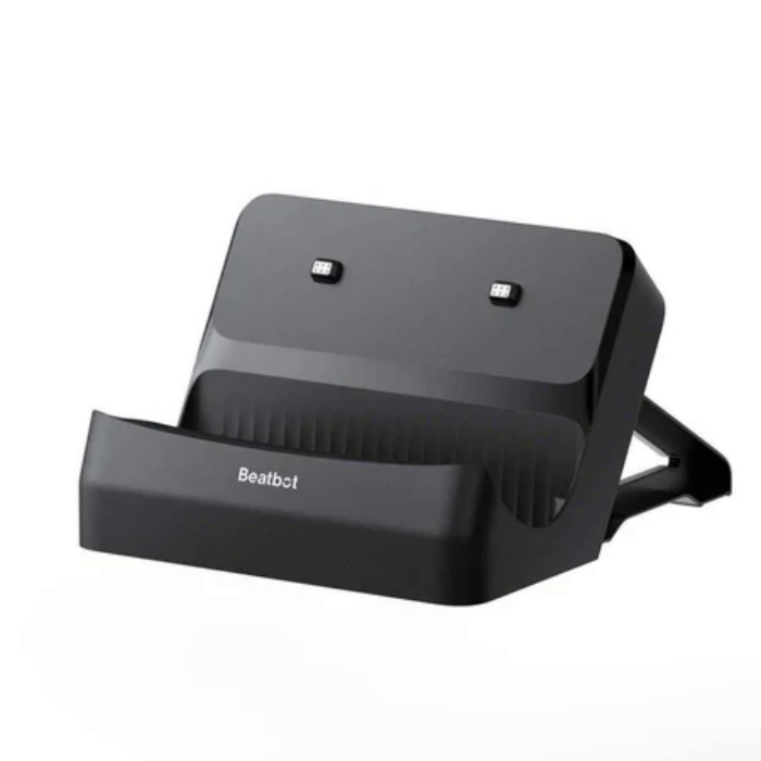 The BEATBOT CHARGING BASE, in black with a slanted design, features two rear charging contacts and a wide front cradle for devices, displayed on a plain white background.