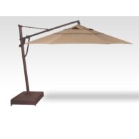 The Cantilever Brz/Sesame 13 patio umbrella features a square tan canopy and dark brown metal stand, positioned to the left. It is open and angled, casting a shadow on a white background.
