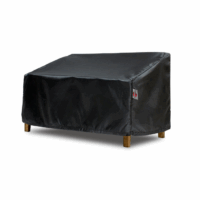 The Wide Loveseat Cover, in black, fits over a two-seater outdoor bench with wooden legs, protecting it from dust and weather elements.