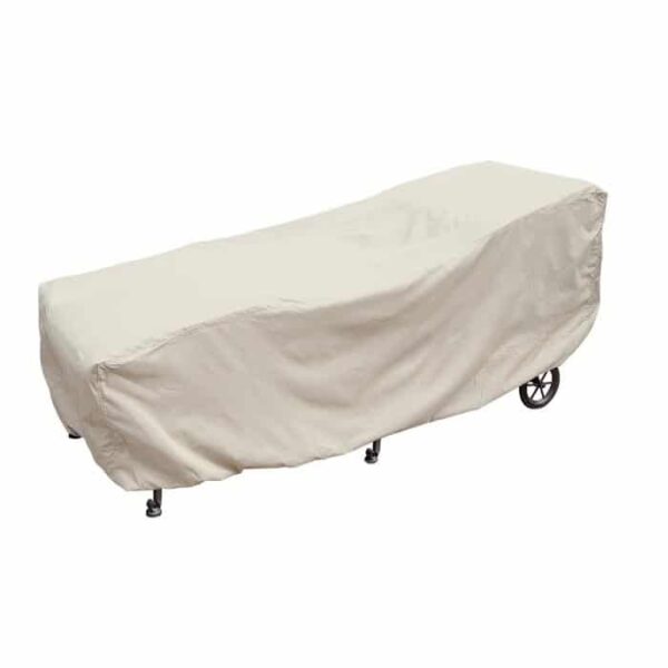 A beige elastic cover is draped over a large Chaise Lounge, partially concealing its shape and legs.