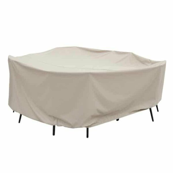 A beige protective cover with ties draped over a 60 round table and chairs, black chair legs visible underneath.