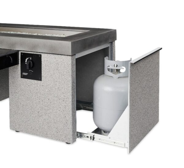 The Uptown Gas Firepit Table features a gray finish, a control knob, and a side panel that opens to reveal a white propane tank stored inside a pull-out compartment.