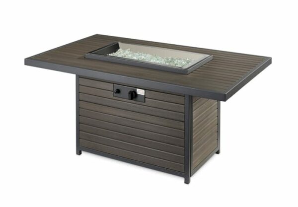 The Brooks Firepit Table features a rectangular design with a wood-look finish, a central glass-filled burner area, and front panel control knobs.