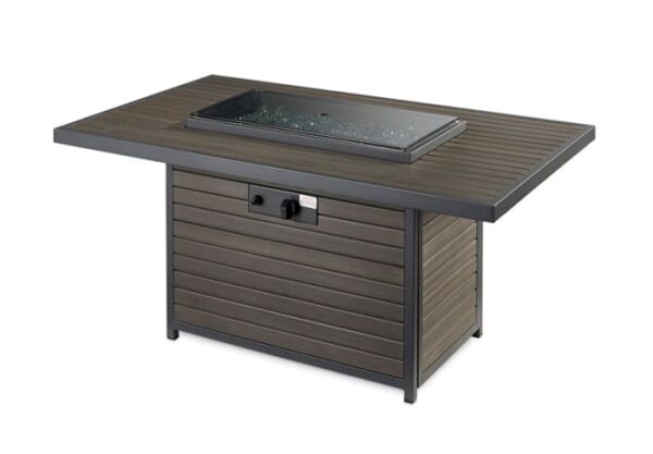 The Brooks Firepit Table features a dark wood-look slatted finish, black metal frame, glass-encased central burner, and front control knobs for outdoor use.