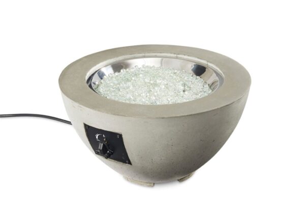 The Cove Gas Firepit Bowl 20 features a round concrete exterior, a metallic inner bowl with clear glass beads, and a side control knob with an attached power cord.