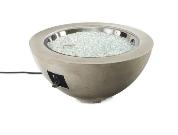 The Cove Gas Firepit Bowl 30 features a round, modern design with a concrete base, clear fire glass, and metal burner. It includes an ignition knob and power cord on the side for easy operation.