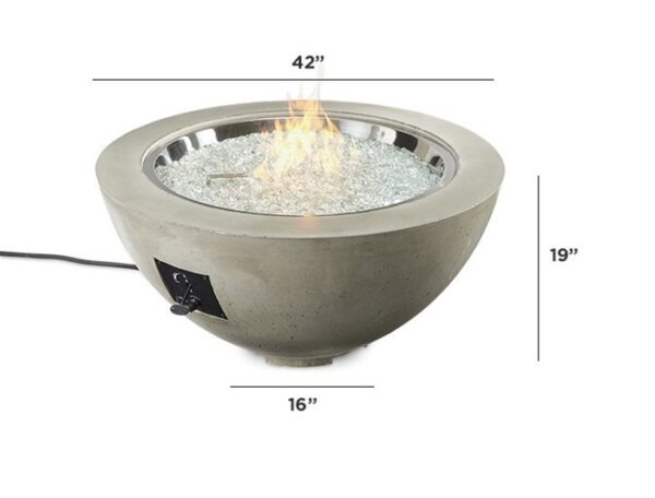 The Cove Gas Firepit Bowl 30 is a round concrete fire pit with glass beads inside, a control knob on the side, and a visible power cord. It measures 42 wide, 19 tall, and 16 deep, with the fire lit in the center.