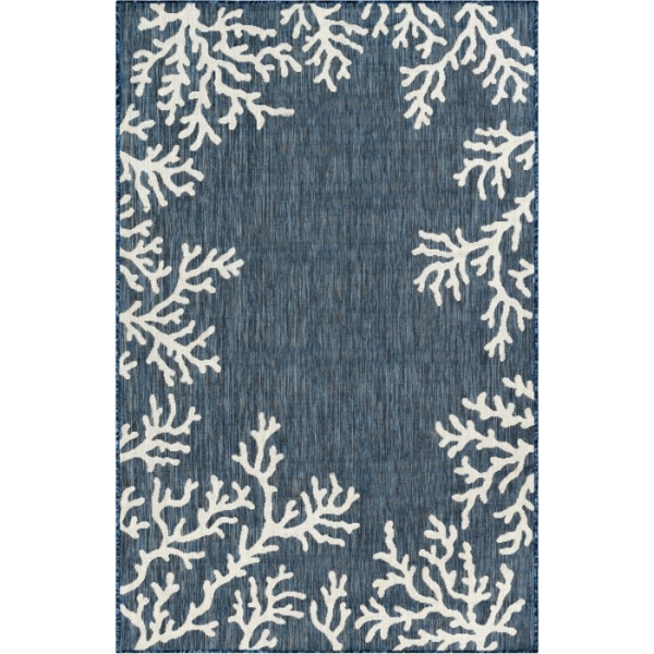 The Outdoor Rug-Coral Border Navy is a rectangular blue rug with a subtle texture, featuring white coral reef designs along the corners and edges while keeping the center mostly clear.