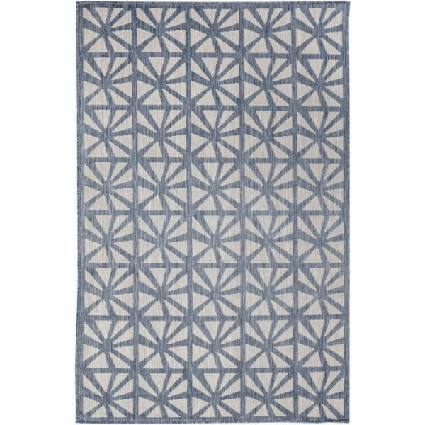 The Outdoor Rug-Tonga Tile Navy features a repeating geometric pattern of blue and white interlocking triangles on a light background, creating a modern and symmetrical look for your space.