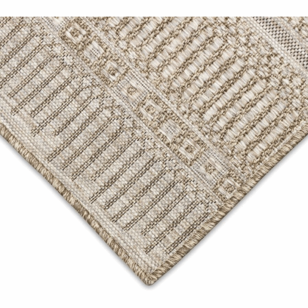 Close-up of the Outdoor Rug-Striped Natural, featuring a woven beige and cream geometric pattern in earthy tones. The edge is finished with a thick, braided border for added durability and style.
