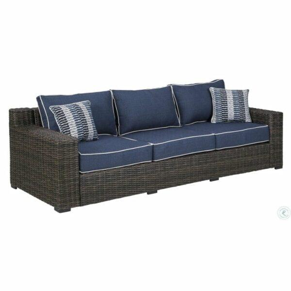 The Grasson Lane 5-Piece Grouping features a wicker outdoor sofa with a dark brown frame, navy blue cushions with white piping, and two geometric-patterned accent pillows.