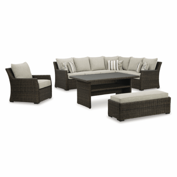 The Brook Ranch Grouping 4-Piece includes a wicker outdoor sectional sofa with seven beige cushions and two striped accent pillows, a single armchair, a rectangular table, and a bench.