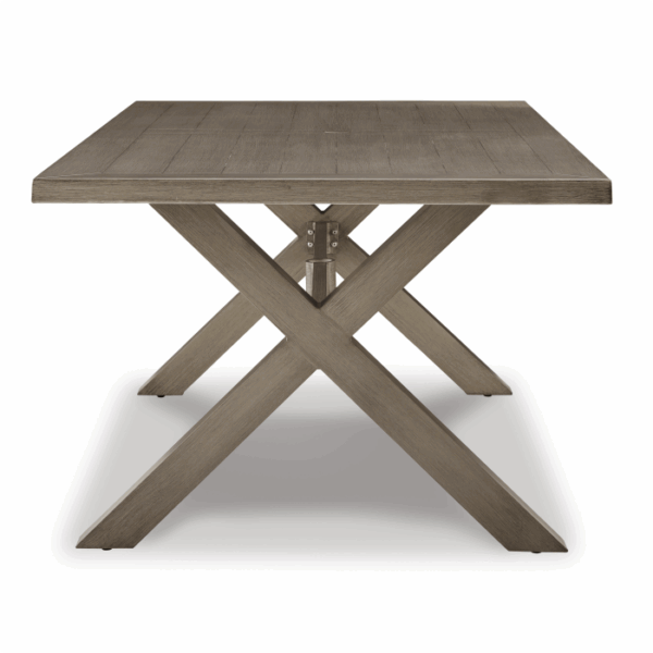 The Beach Front Wicker Set 7 piece, featuring a rectangular dining table and X-shaped base, is displayed from the end against a white background.