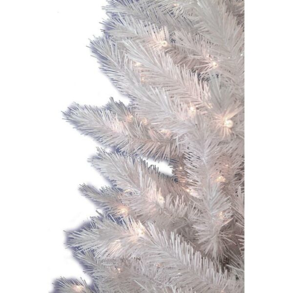 Close-up of the 7 Arctic Pine (C) artificial Christmas tree, featuring glowing white string lights woven through its white branches, set against a plain white background.