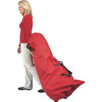 A woman in a red turtleneck and light pants pulls the Rolling Tree Bag 9FT, a large red wheeled bag with black handles, against a white background.