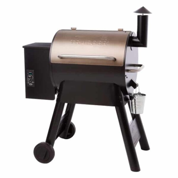 A bronze Traeger Pro Series 22 Grill with a barrel-shaped body, chimney, control panel, two wheels, and a drip bucket on one side.