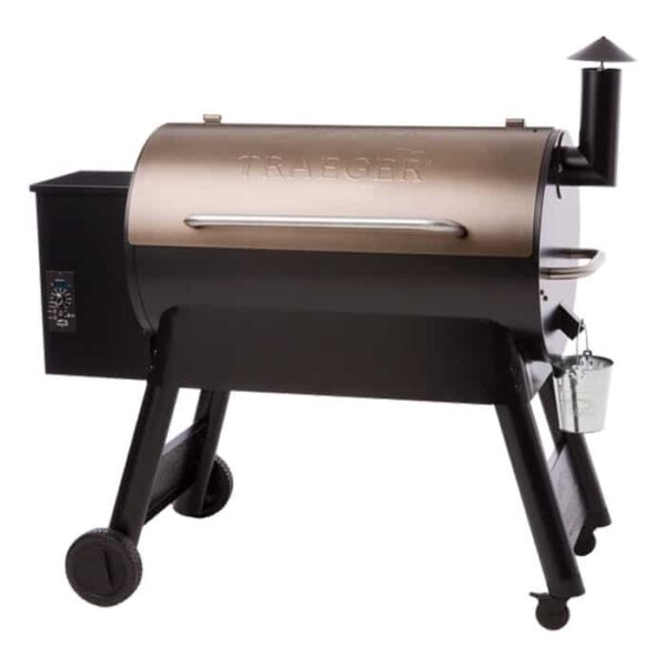 The Pro Series 34 Grill - Bronze is a black and bronze Traeger pellet grill and smoker with four wheeled legs, a side smokestack, digital control panel, and attached metal bucket for ash or grease collection.
