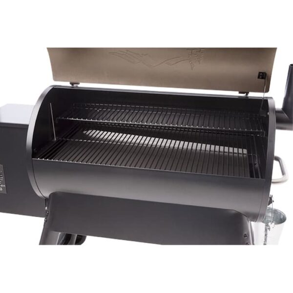 A close-up of the Pro Series 34 Grill - Bronze with its lid raised, revealing two metal racks and a spacious cooking area, ready for grilling.