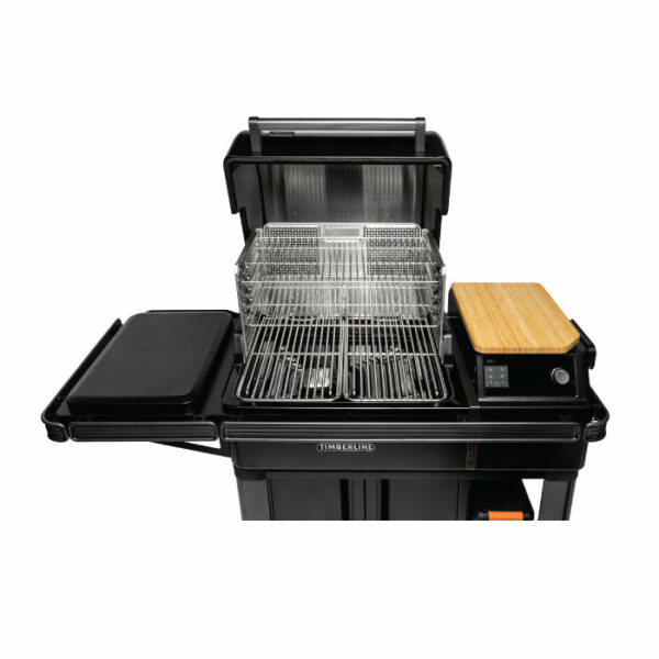 The Timberline 2022 is a black outdoor grill featuring an open lid, wire cooking racks, a closed side compartment, a wooden cutting board, and an electronic control panel on the right side.