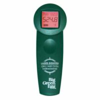 A Big Green Egg Infrared Cooking Thermometer with a green laser-sighted display shows a temperature reading of 524.8°F on its digital screen.