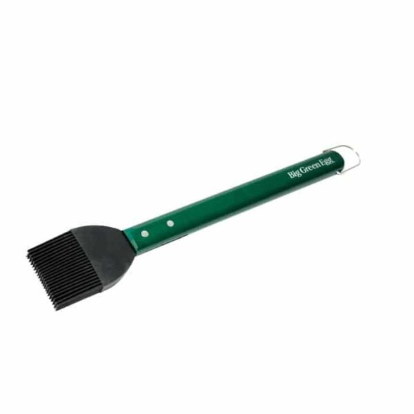 The BGE-Premium Basting Brush features a green silicone handle with the Big Green Egg logo, a metal loop for hanging, and is designed for grilling or cooking.