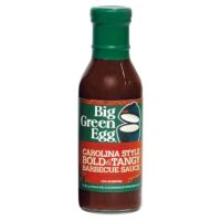 A 12 oz (355 ml) bottle of Carolina Style BBQ Sauce with a green cap and label, grill logo, and orange text.