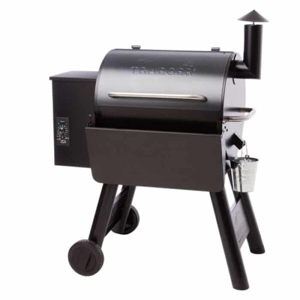 The TRAEGER Folding Front Shelf-22 Series is a black pellet grill smoker with a left control panel, chimney, lid handle, wheeled legs, and a metal bucket hanging on the right side.