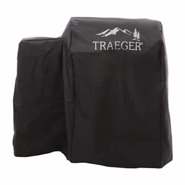 The Full-Length Grill Cover - 20 Series, in black with the Traeger logo and a mountain and trees graphic, is shown draped over an outdoor grill.