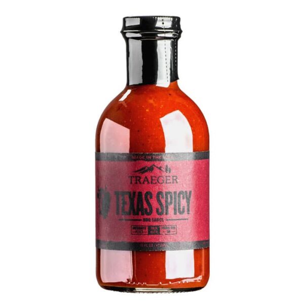 A glass bottle of Traeger Texas Spicy BBQ Sauce with a black cap and red label, bold black lettering, and a pepper graphic on the left side.