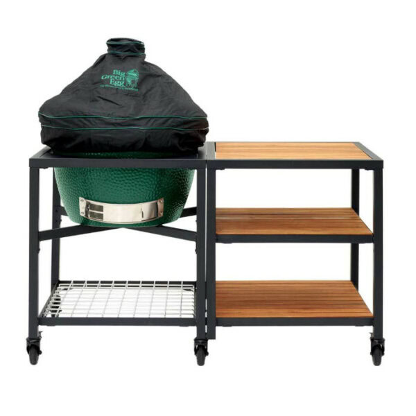 A green ceramic grill with the BGE-Universal Dome Cover LG/XL sits in a black metal and wood rolling cart featuring shelves and a wire rack, designed for outdoor cooking and storage.