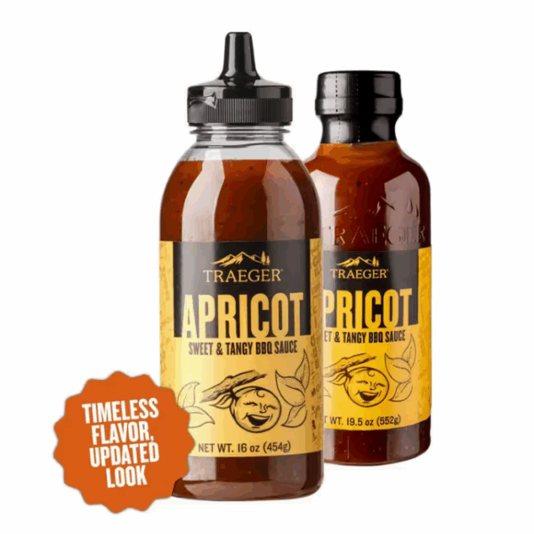 Two bottles of TRAEGER-Apricot 16 OZ Squeeze BBQ Sauce with yellow labels are shown. An orange badge says Timeless Flavor, Updated Look.