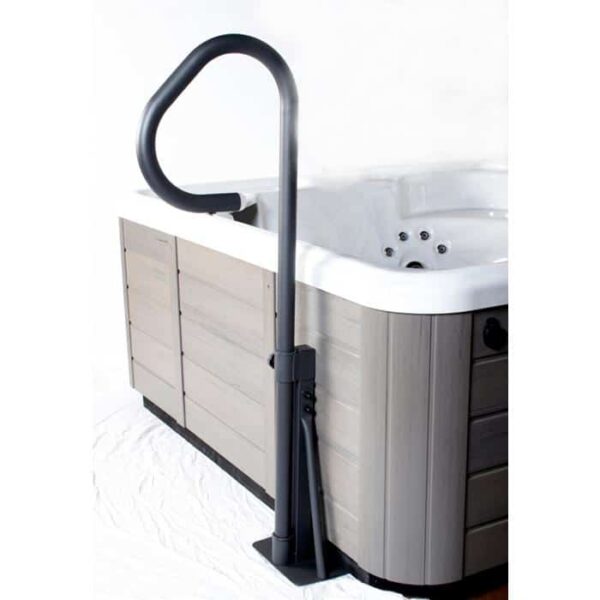 An LED Spa Handrail with Base is installed beside a modern hot tub with wood-panel sides and a white interior, offering illuminated support for safe entry and exit.