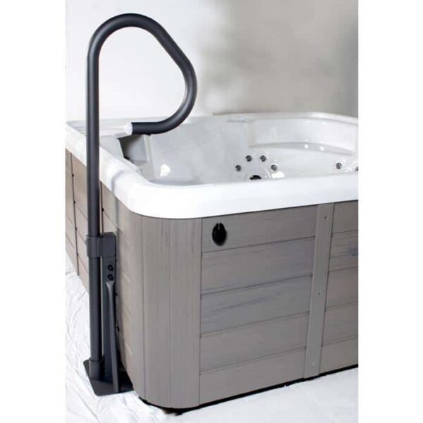 A gray and white hot tub features the LED Spa Handrail with Base in black, securely installed at the corner to provide sturdy support when entering or exiting the spa.