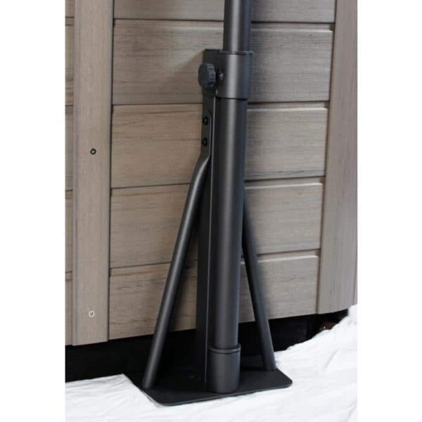 A close-up of the LED Spa Handrail with Base shows its black metal support pole with angled braces, flat base mounting, and attachment to a wood-textured wall, resting on a white surface.