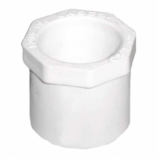 The 1 Spigot x 1/2 Slip Reducer is a white PVC pipe fitting with a hexagonal top and cylindrical body, designed for connecting pipes of different sizes in plumbing.