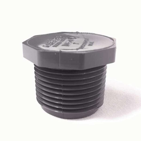 A close-up photo of a Plug, 1/2 MPT (SCH 80), a black plastic, hex-head threaded fitting often used as a pipe cap, shown on a light surface.