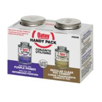 A box labeled PVC Glue & Primer Handy Kit 4oz holds two metal cans—purple PVC primer and clear PVC cement. Text appears in English and Spanish, with product name and usage info on the packaging.