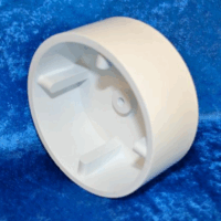 A YOKE CAP, a white, hollow, cylindrical plastic piece with four inner prongs, is shown on a bright blue textured background.