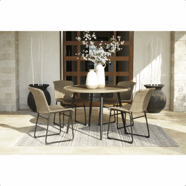 The Amaris Dining Set 5-piece features four wicker chairs and a round table with two vases, arranged on a patterned rug in an outdoor patio. Decorative planters and a wooden glass-panel door complete the inviting setting.