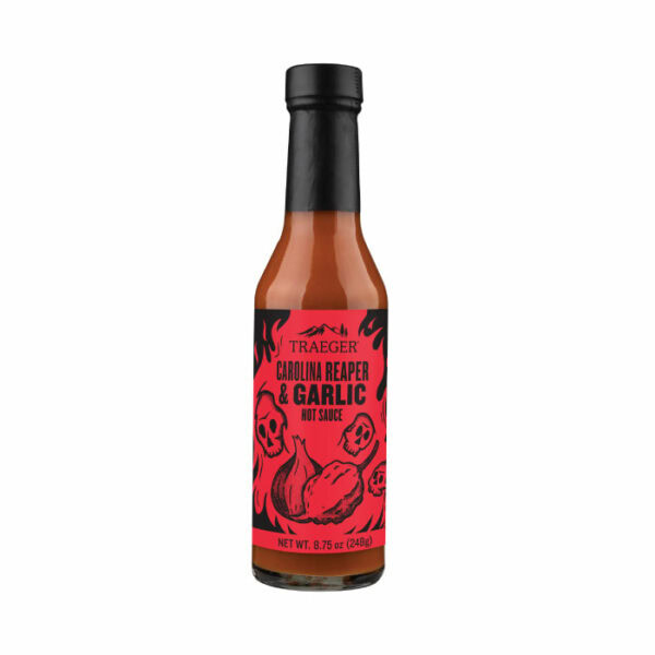 An 8.75 oz (248g) bottle of Traeger Carolina Reaper & Garlic Hot Sauce with a red label displaying black illustrations of peppers, garlic, and flames.