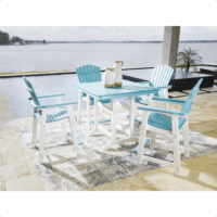 The Eisely Counter Set 5-piece, featuring four blue and white chairs and a rectangular table, sits on a rug by the pool with two pitchers and cups atop, overlooking a lake surrounded by trees.