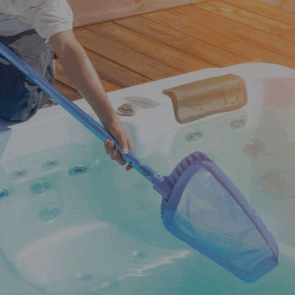 A person uses the Spa Opening to clean a hot tub, with a wooden deck and jacuzzi jets visible in the background.