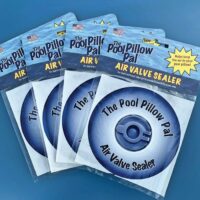 Four packs of Air Valve Sealer Pillow Pal are shown on a blue surface, each with blue and white circular packaging and a small American flag in the top left corner.